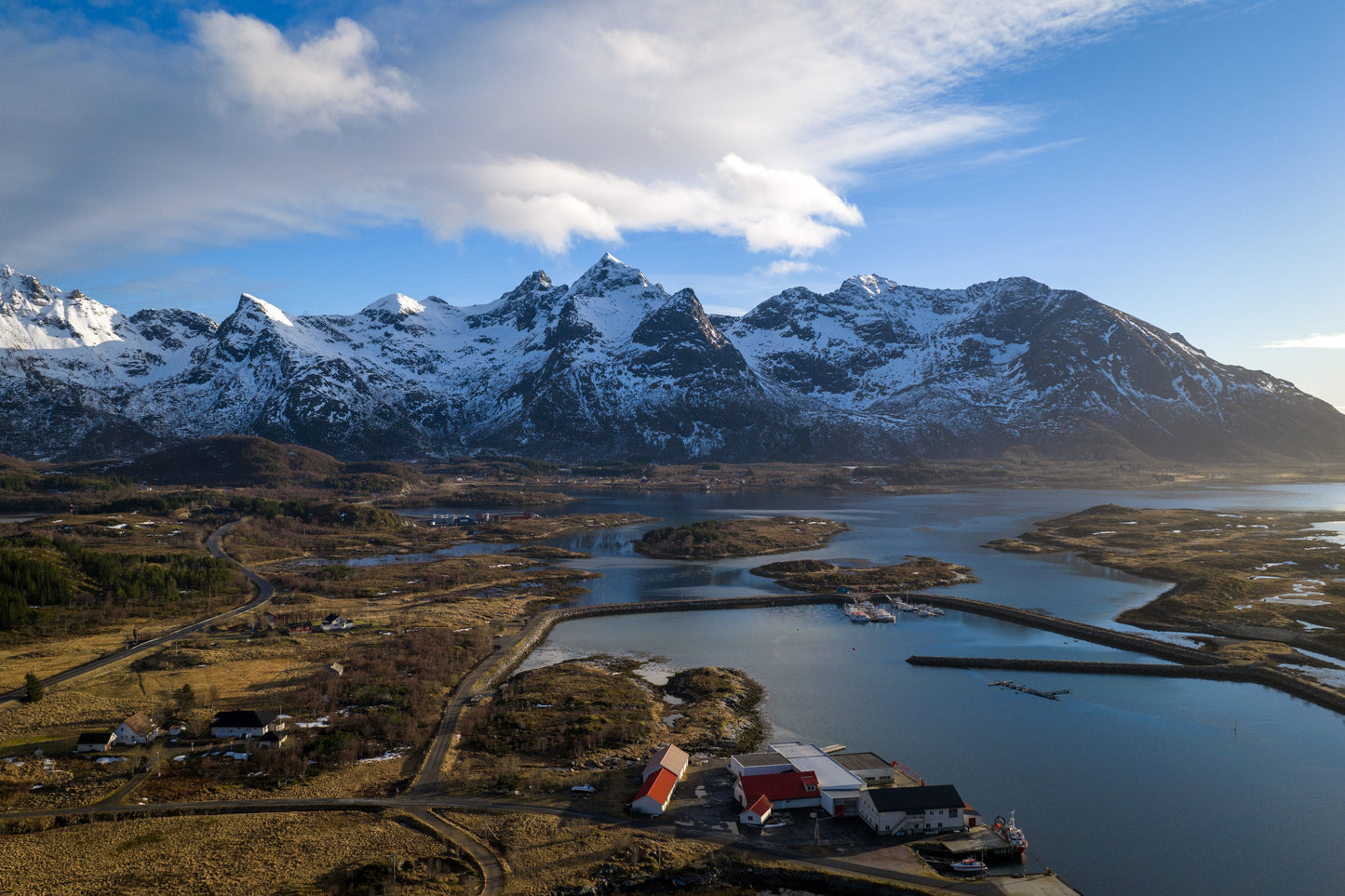 Aerial drone view of Reine fishing village with dramatic sky, Lofoten Norway